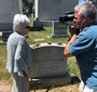 Kaya Mirecka Ploss at Jan Karski's grave at Mt. Olivet Cemetry in Washington, D.C., during the filming of the documentary Everything Is in Your Hands (holding the is camera its director, Sławomir Grünberg) (Photo: Courtesy of LOGTV/Sławomir Grünberg )