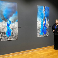 The artist in front of her artwork exhibited at the Center for Persecuted Arts in Solingen, Germany (Photo: Courtesy of Anna VanMatre)