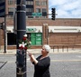 Loyola University Professor, Bożena Nowicka McLees at the Jan Karski Way street sign in Chicago, IL (Photo: Marek Adamczyk)