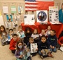 Students from the Jan Karski Polish School in Palos Heights show off their Karski artwork. (Photo: Courtesy of Marek Adamczyk)