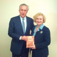 Mr. Rojek presents the book to Dr. Kurtinitis