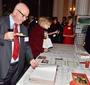 The bid sheets at the silent auction table attract attention (Krzysztof Osipowicz)