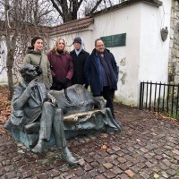 The Krakow sightseeing included a must-visit to the Karski bench at the Kazimierz District. From the left: Madeleine Claire Kelley (manager), Laura Smith (stage manager), Clark Young (co-writer), and Derek Goldman (co-writer and director). (Photo: Bożena U. Zaremba)