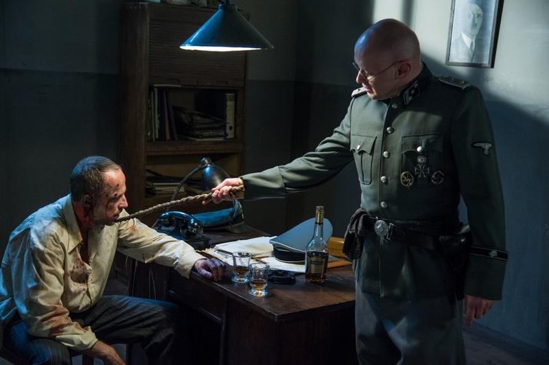 Reenactment of Karski's ordeal during the interrogation with a German officer: Łukasz Similat (Karski) and Wojciech Kalarus (German officer). (Photo: Wojciech Todorow)