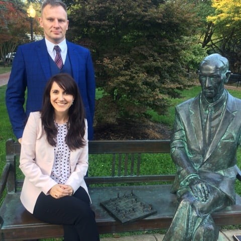 Recipients of the Jan Karski Educational Foundation's scholarship, Izabela Hrynek and Daniel Szczęsny, at the Jan Karski bench on the Georgetown University Campus, while participating in the 2019 Georgetown Leadership Seminar (Photo: Courtesy of the pictured)